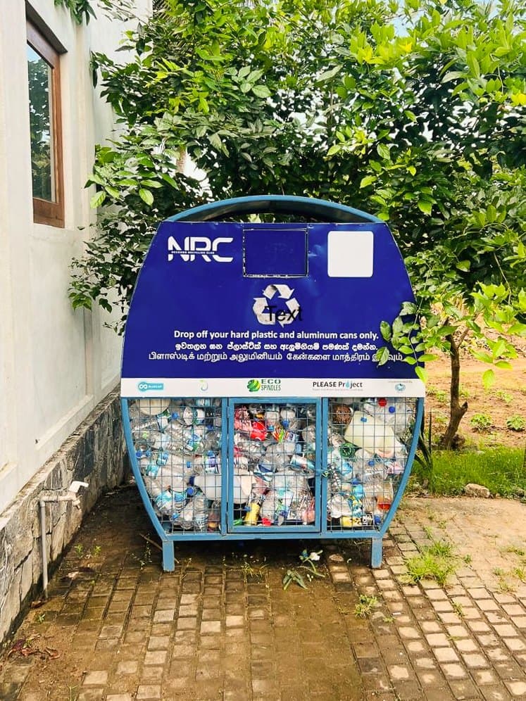 An NRC drop-off bin filled with collected bottles at a neighbourhood collection point.
