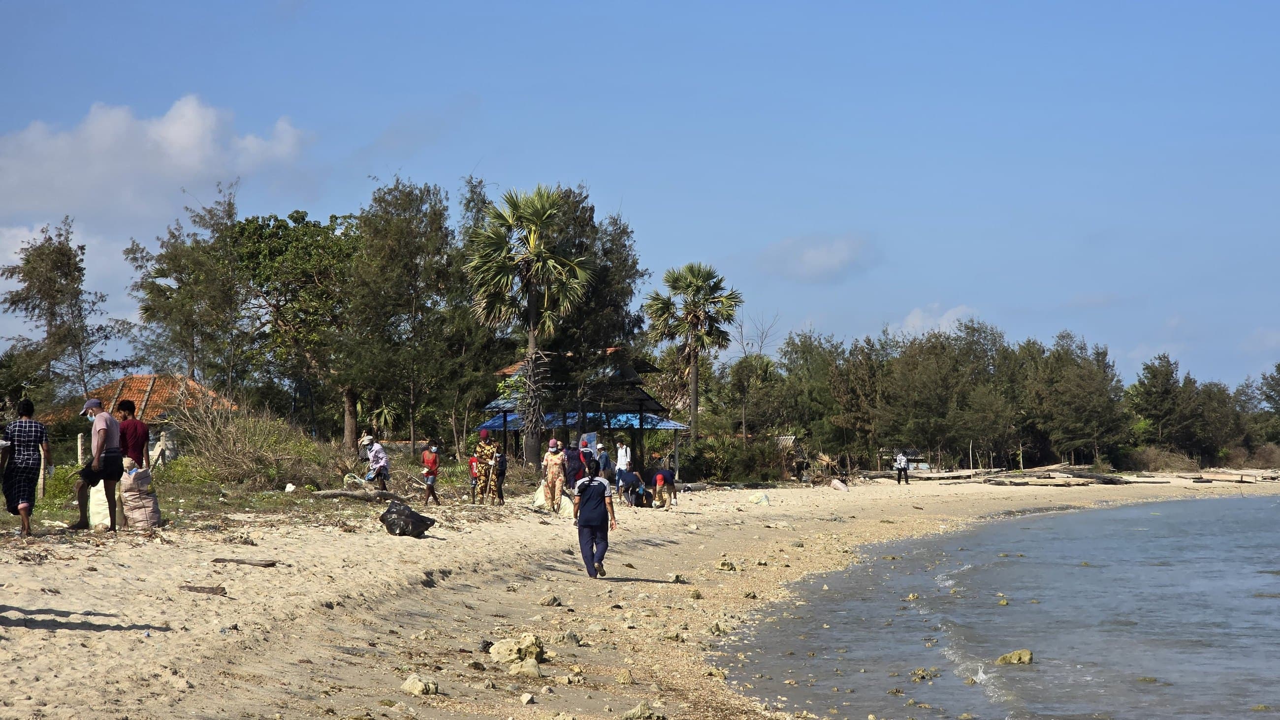 NRC beach cleanup on a rocky stretch of coastline.